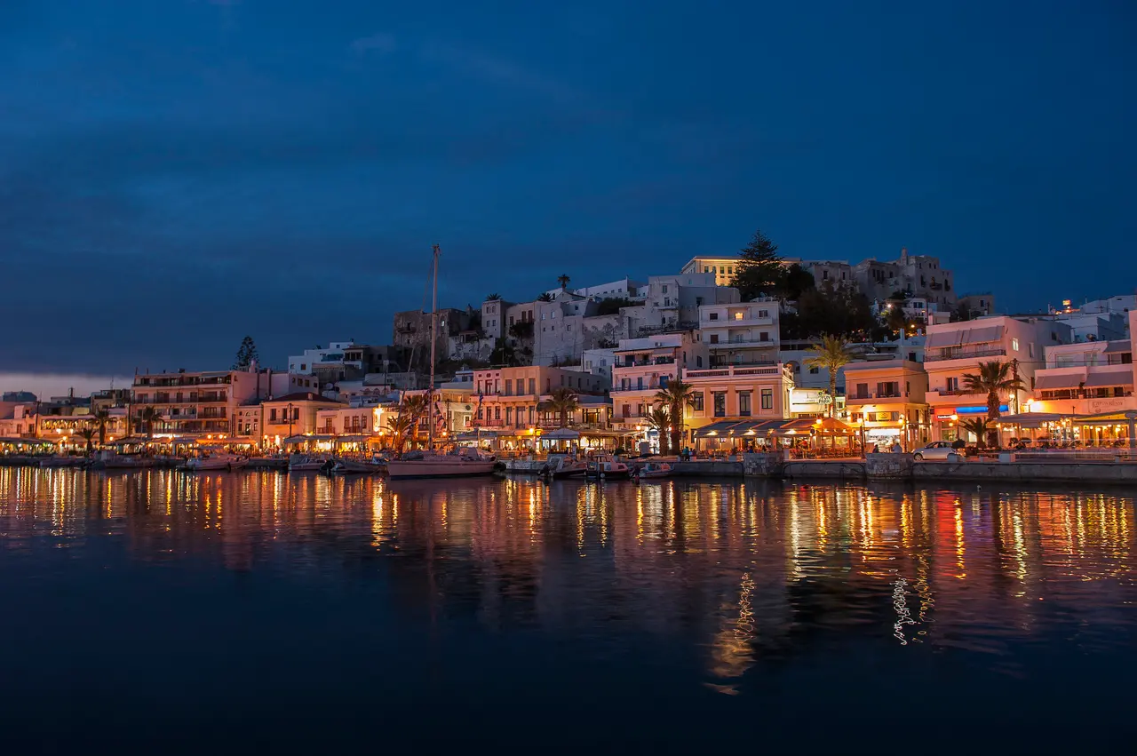 Chora's lit waterfront at dusk